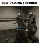 two soldiers are holding guns in a room with the words just passing through on the bottom .