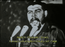 a man with a beard is speaking into a microphone with the words ready to slit people 's throats