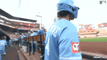 a baseball player wearing a blue jersey with the number 21 on the back