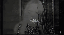 a close up of a woman 's face with a microphone on her head .
