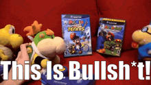 a video game called mario power tennis sits on a couch next to stuffed animals