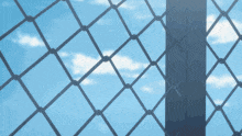 a fence with a blue sky in the background