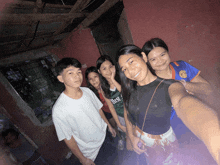 a group of young people posing for a picture with one girl wearing a green shirt that says best