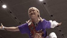a woman wearing a purple shirt that says mic