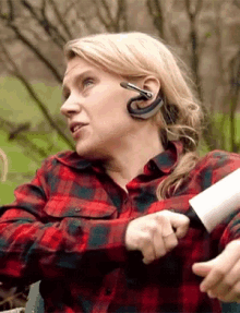 a woman wearing a headset holds a knife in her hand