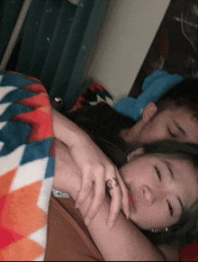 a woman with a ring on her finger is laying on a man 's chest
