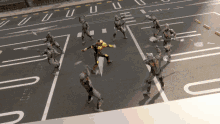 a group of soldiers are fighting on a street with the letter u in the middle of the road