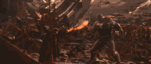 a person is standing in front of a fireball that is coming out of the ground
