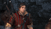 a man with a bloody face is wearing a red jacket with spikes