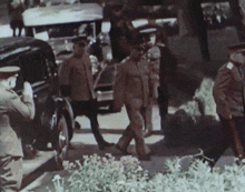 a group of men in military uniforms are walking down the street