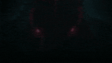 a close up of a dragon 's eyes with red lights coming out of them