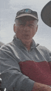 a man wearing a hat with the letter f on it is looking at the camera