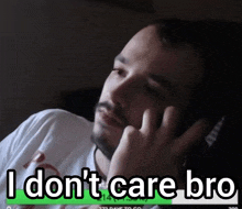 a man talking on a cell phone with the words i don 't care bro on the bottom