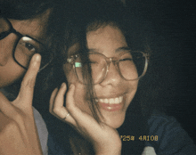 a girl wearing glasses and a man wearing glasses are posing for a photo on april 10th