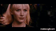 a close up of a woman 's face with make a gif.com in the bottom left corner
