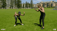 a man and a woman are standing in a grassy field with the hashtag mafs