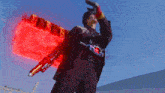 a man is holding a gun with a red light coming from it