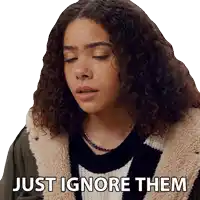 a woman with curly hair is wearing a sticker that says just ignore them