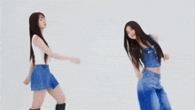 a woman in a white tank top with the letter g on it is dancing with two other women