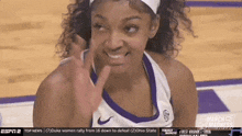 a female basketball player is giving a high five while wearing a headband