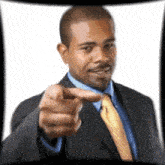 a man in a suit and tie is pointing his finger at the camera