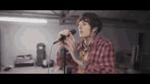 a man is singing into a microphone in a room .