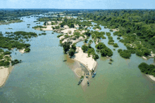 an aerial view of a large body of water with a small island in the middle