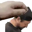 a man with a beard is getting his head rubbed by another person 's hand .