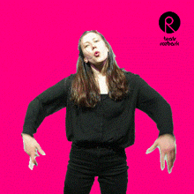 a woman in a black shirt is dancing in front of a pink background that says teatr rozbark on it