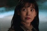 a close up of a woman with a sad look on her face