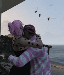 a woman with pink hair is hugging a man in a pink and white shirt