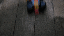 a blurred image of a wooden surface with a red and yellow stripe