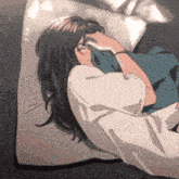 a woman is laying on a bed with her head on a pillow and covering her face with her hand .