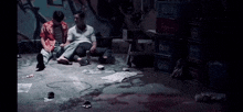 a group of men are sitting on the floor in a room with crates .