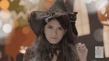 a woman in a witch costume with ukt 48 on the bottom