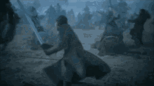 a man is standing in front of a crowd of people in a field .
