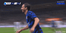 two soccer players hugging each other during a cbs sports broadcast