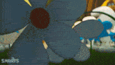 a bunch of smurfs are standing around a flower