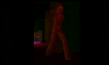 a person is standing in a dark room with red lights coming out of their eyes .