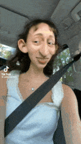 a woman is wearing a seat belt in a car and has a cartoon face