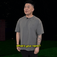 a man in a grey t-shirt is asking what 's your name