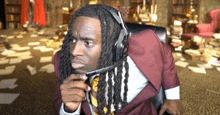 a man in a suit and tie is wearing headphones and a microphone .