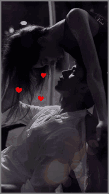 a black and white photo of a man and a woman kissing with the name victoria on the bottom