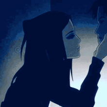 a man and a woman are touching each other 's faces .