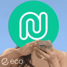 a woman is holding a stack of money in front of a green circle with the letter m on it