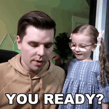 a man and a little girl are standing next to each other and the little girl is asking the man if he is ready