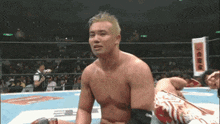 a man in a wrestling ring with a sign that says ' a ' on it .