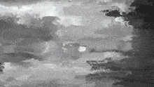 a black and white image of a cloudy sky with a search bar in the corner