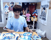 a man sitting at a table with a wanted poster on the wall