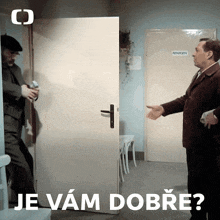 two men are shaking hands in front of a door that says röntgen on it